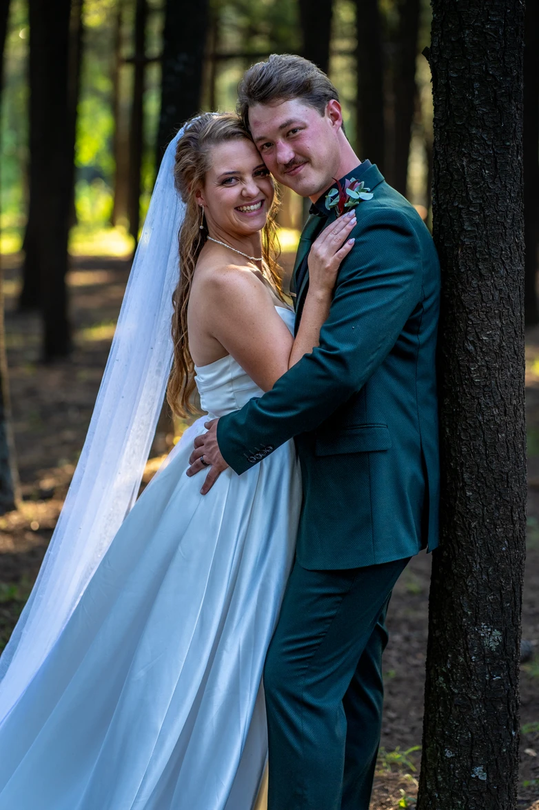 Bride and groom in a pine forest